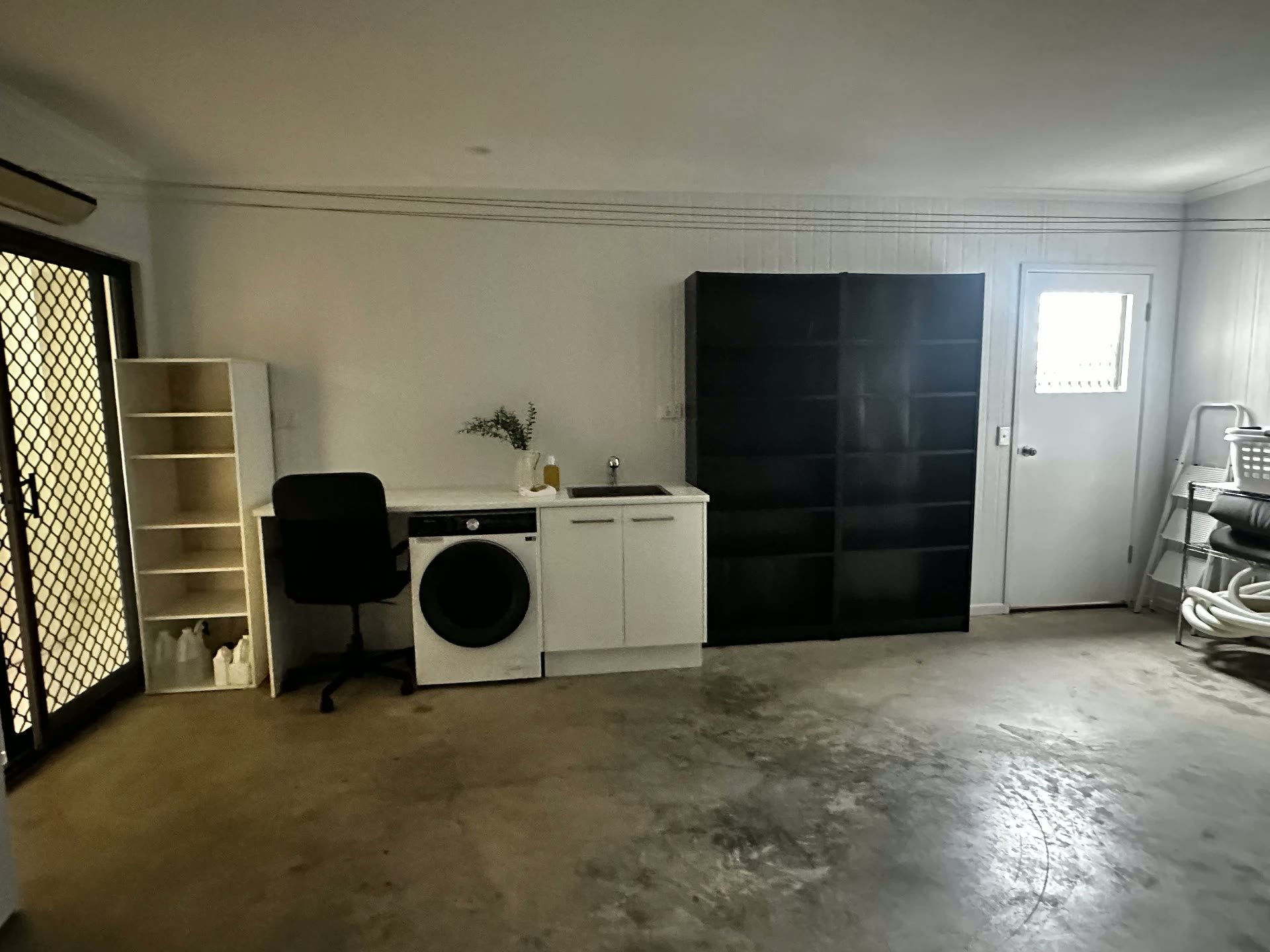 Existing garage and laundry area within the property