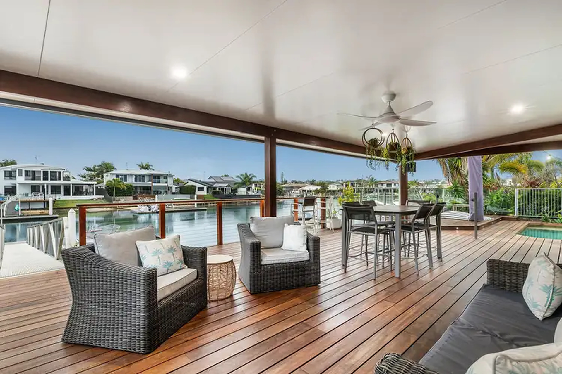 Canal-side veranda and outdoor entertaining area overlooking the water