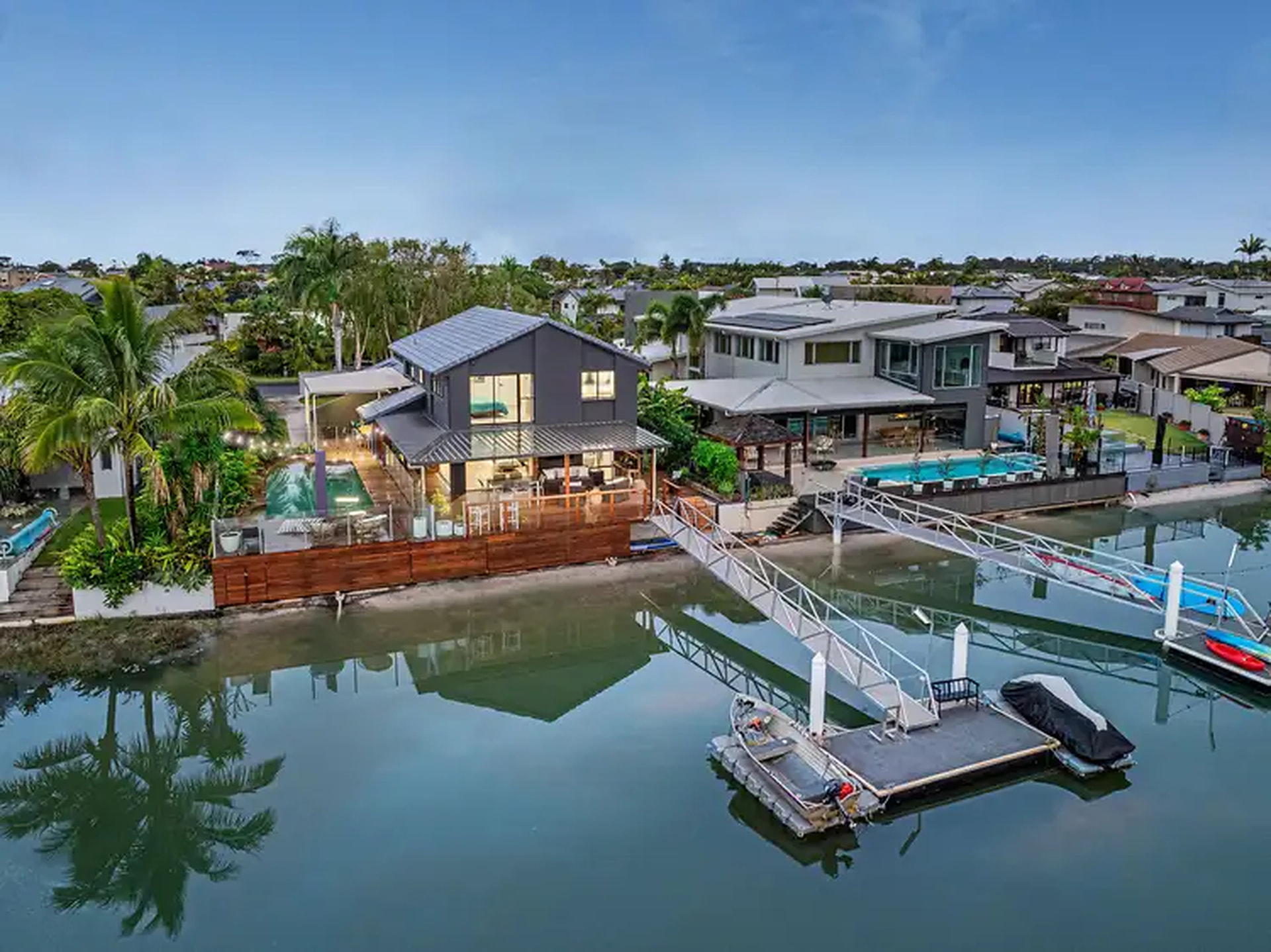 Aerial view of the home, pool, deck and canal frontage